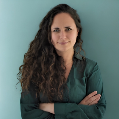 Lauren Alani, Director of Digital Innovation at Seuss+, editorial portrait in forest green blouse